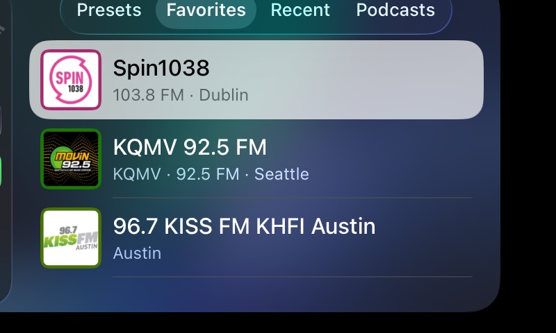 varostream in CarPlay: the Favorites tab, listing stations from Dublin, Seattle and Austin, each logo framed in the station's colour.